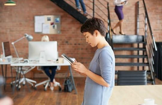 Woman looking at a website on her phone to illustrate the concept of rethinking your website in the age of AI.