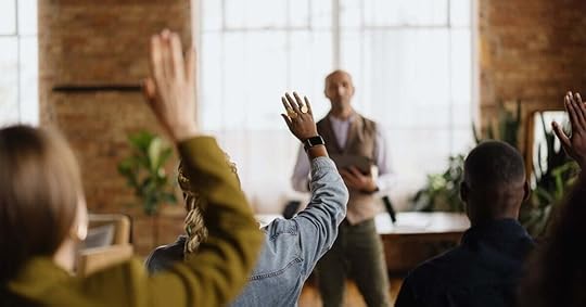 A sales training facilitator takes questions during a session.