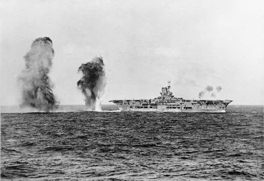 Bombs falling astern of HMS Ark Royal during attack by Italian aircraft during the Battle of Cape Spartivento, 27 Nov 1940; photograph taken from cruiser HMS Sheffield (Imperial War Museum: 4700-01 A 2298)