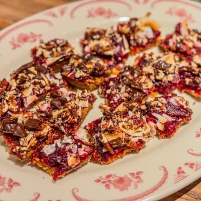 A plate of cranberry magic bars with coconut, pecans, and chocolate.