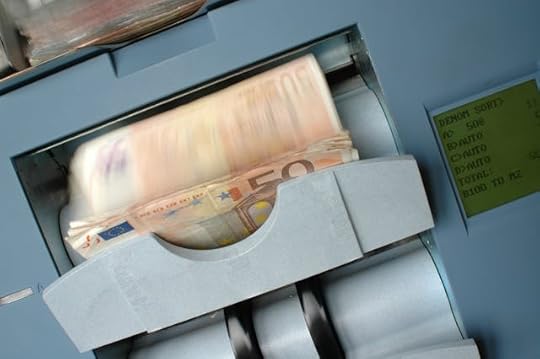Close-up of euro banknotes being counted in a money machine, symbolizing how clearing subconscious blocks allows abundance and financial flow to increase naturally.