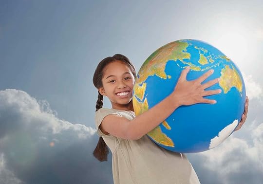 A young girl with a big smile and her arms around a big globe