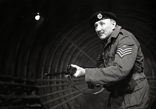 Reference photo from The Web of Fear, showing Jack Woolgar as Staff Sergeant Arnold, care of the Black Archive