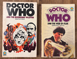 First edition paperbacks of Doctor Who and the Doomsday Weapon and Doctor Who and the Web of Fear, cover art by Chris Achilleos