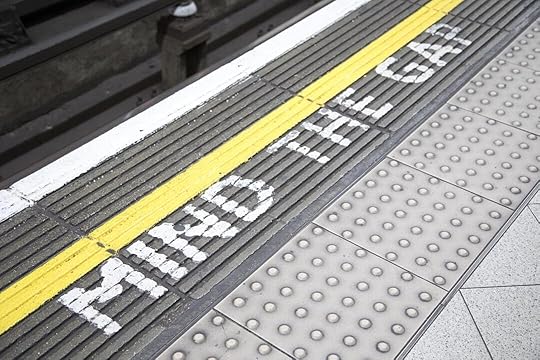 a train platform with the word train stop painted on it