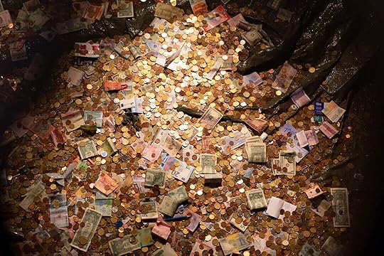 A pile of money sitting on top of a pile of coins