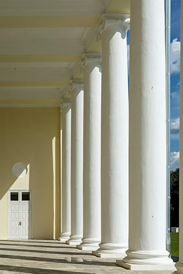 A row of white pillars in front of a building
