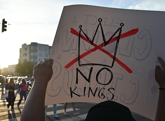 Protesters hold a sign that says 