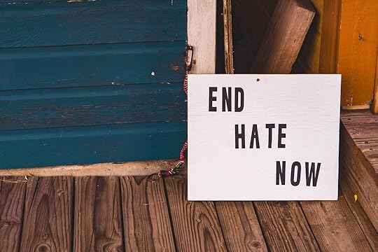 a sign that says end hate now on a porch