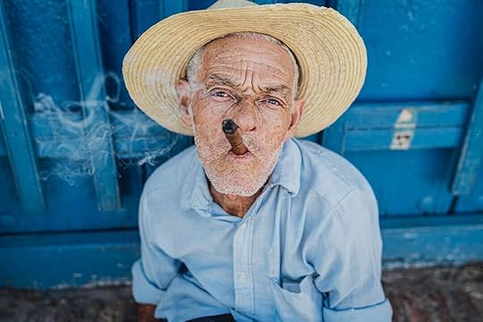 man in blue dress shirt wearing brown straw hat