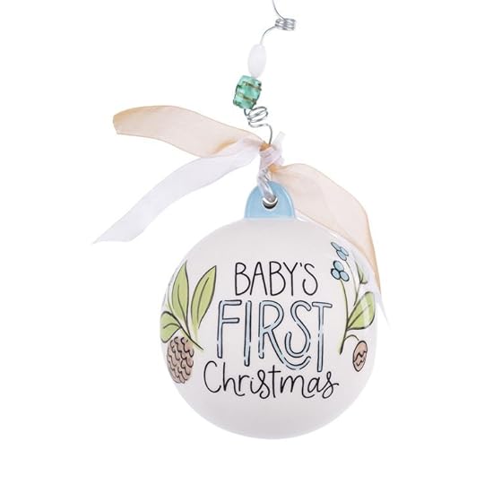 This may contain: a baby's first christmas ornament hanging from a ribbon