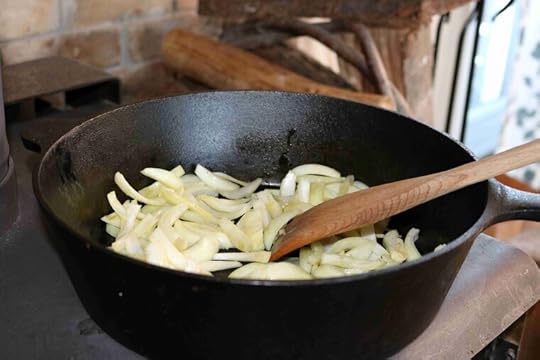 Sauteeing onions in a cast iron pan on a wood stove
