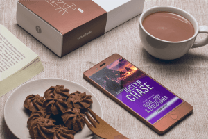 Judge, Jury, & Executioner, by Joslyn Chase on cell phone screen next to chocolate cookies and a cup of cocoa