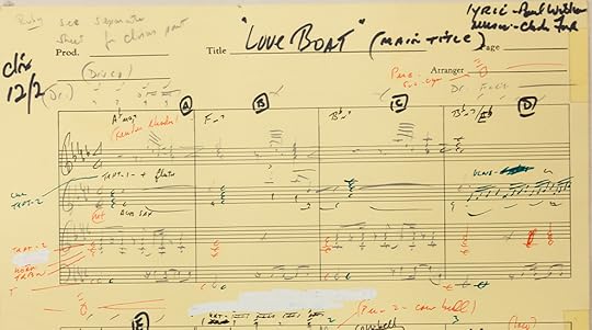 A close up of the top of yellowish page of sheet music, with musical notes and handwritten annotations. 