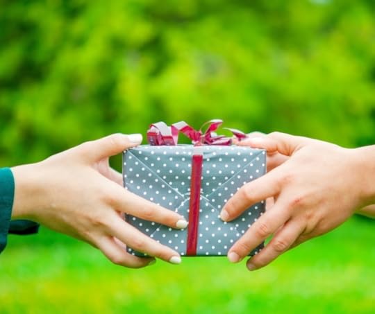 close up photo of handing off a gift, illustrating the idea that you might contemplate if you dislike giving or receiving gifts and if so, why that is