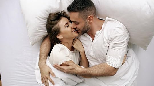 Couple kissing passionately in bed