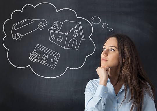 Woman looking at a chalkboard thought bubble of a car, house, and money—how to shift your money mindset with clear goals.
