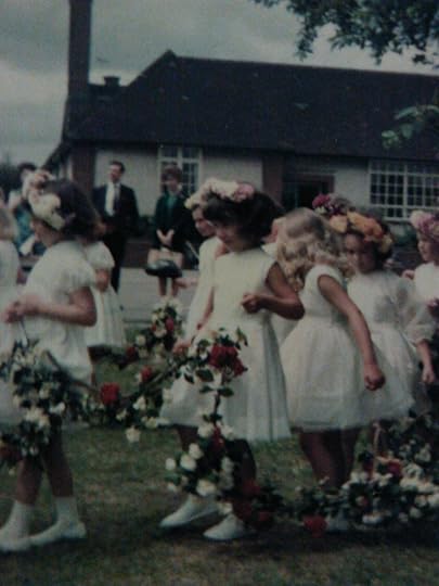 Procession of children in traditional May Day ceremony at English primary school