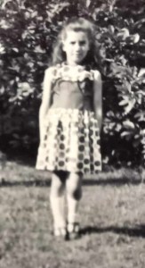 Debbie Young aged about 6 in front of Grandma's magnolia