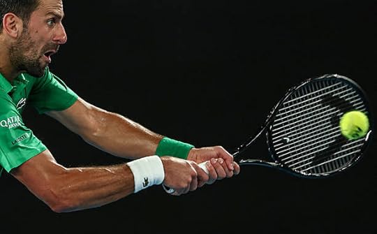Serbia's Novak Djokovic hits a return against Italy's Jannik Sinner during their men's singles semi-final match on day thirteen of the Australian...