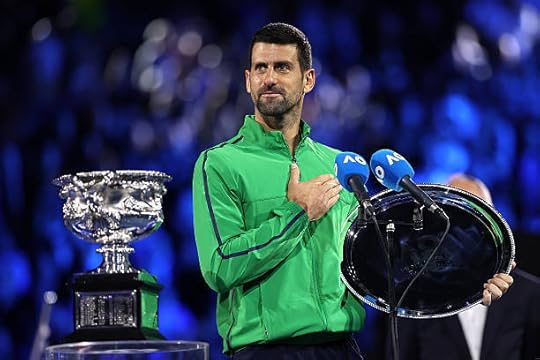 Runner-up Novak Djokovic of Serbia speaks with the finalist plaque at the presentation ceremony after the Men's Singles Final against Carlos Alcaraz...