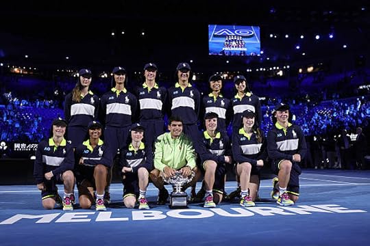 Spain's Carlos Alcaraz poses with ball kids after defeating Serbia's Novak Djokovic in the men's singles final on Day 15 of the Australian Open...
