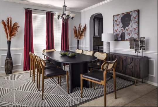 dining room with black table for eight, colorful art and magenta drapes.