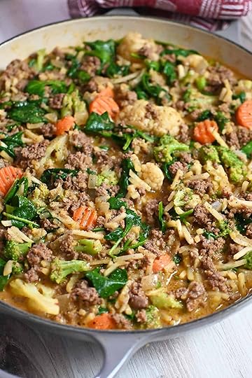 A closeup look of a skillet filled with ground beef, shredded potatoes, and mixed veggies in a savory, gluten-free and dairy-free sauce.