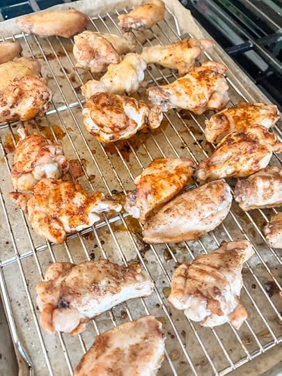 The prepped and seasoned party wings marinating in season