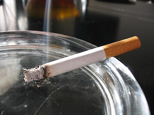 a lit cigarette in an ashtray