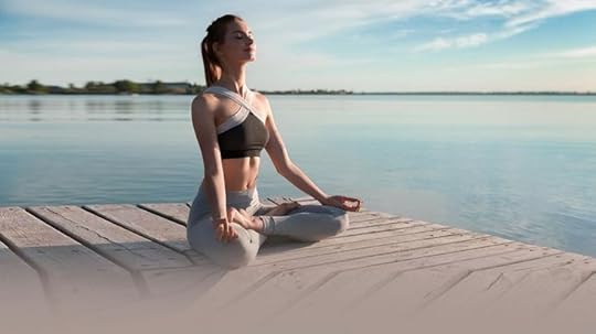This may contain: a woman is sitting on a dock doing yoga