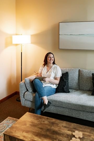 Erin sitting on a couch in her office