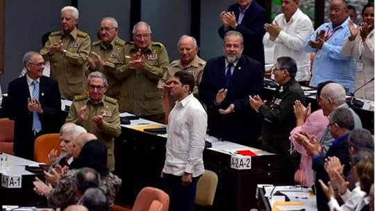 A group of people standing in front of a person standing in front of a tableAI-generated content may be incorrect.