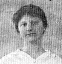 Black and white portrait of a young person with short hair, wearing a white collared shirt, set against a textured background.