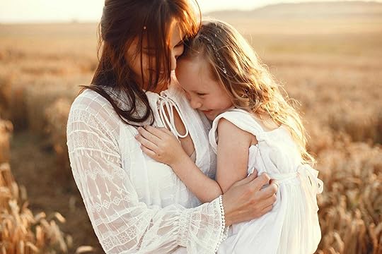 mother and daughter hugging on field - Neurodivergent masking