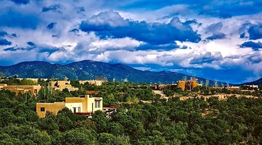 Hillside home in Santa Fe surrounded by lush green foliage.