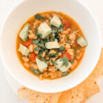 The bowl of chili with toppings and chips