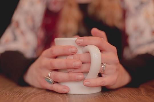 person holding white ceramic mug