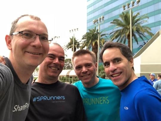 A selfie of me, Jeff Teper and two others wearing #SPRunners tshirts in the Las Vegas heat with palm trees behind us.