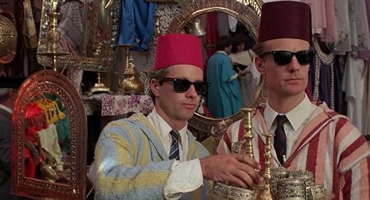 Two CIA agents in sunglasses attempt to blend in at a Morroccan street market