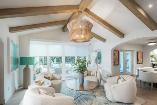 living room with wood beams, woven chandelier and white walls, furniture.
