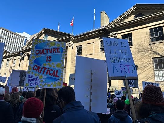 Protesters at Province House carrying signs saying “Culture is Critical: No More Cuts” and “What is Life without Art?”