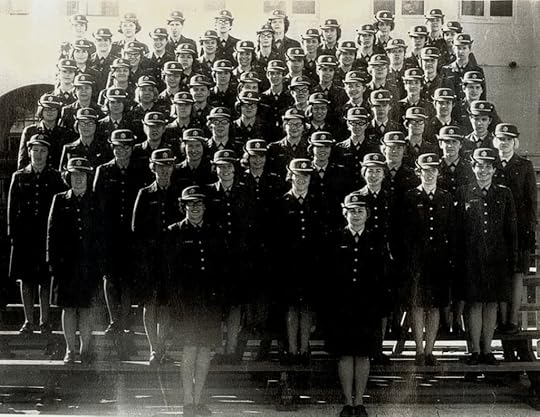 A group portrait of a large contingent of women in military uniforms, standing in rows on a staircase, all wearing hats and dark coats.