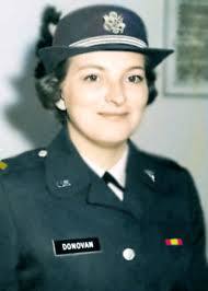 A woman in a military uniform with a hat, smiling at the camera. Her name tag reads 'DONOVAN'.