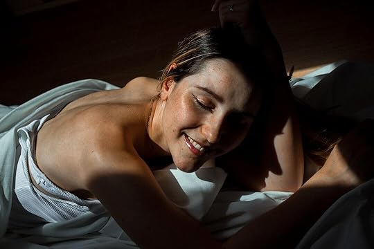 topless woman lying on bed
