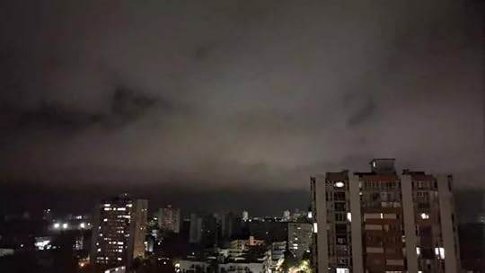 A city at night with dark cloudsAI-generated content may be incorrect.