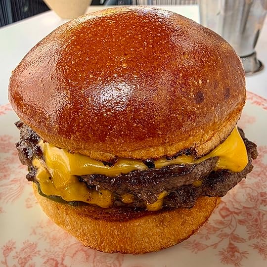 Burger from The Window at The Joyce in Miami Beach with melted cheese and seared patty