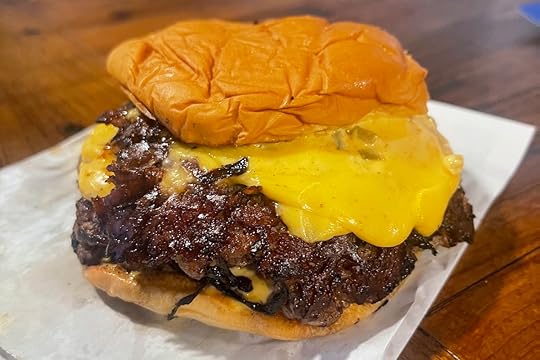 Jefe Smash Burger from Lala’s Burgers and Fries in Miami with cheese, onions, and sauce