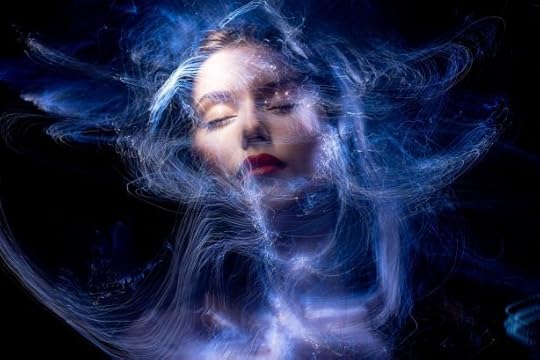 Image of a woman surrounded by magick and blue light
