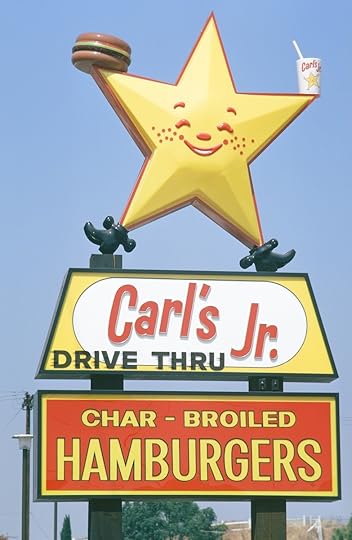 Vintage Carl’s Jr. star sign with hamburger and drive-thru branding